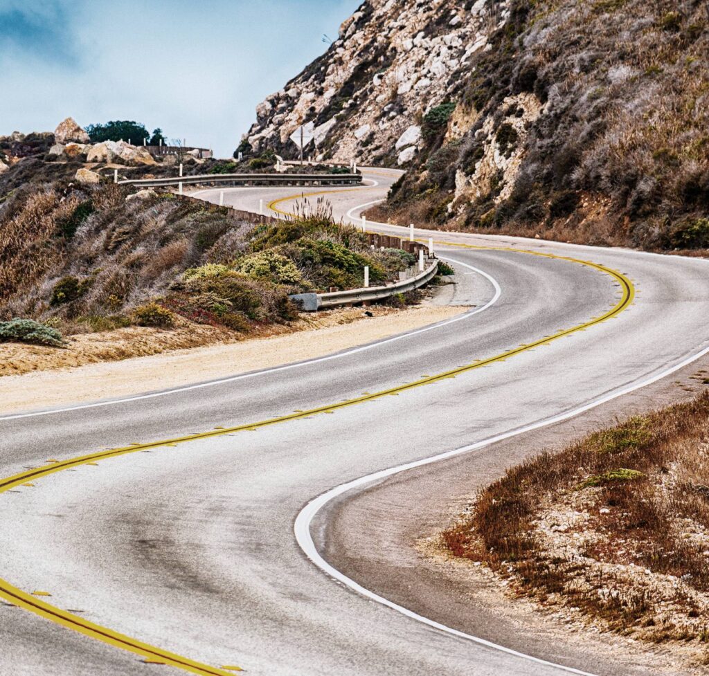 About us 2 Winding road through green hills